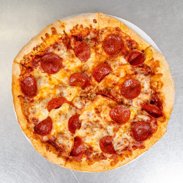 A whole pepperoni pizza with melted cheese and a golden crust on a metal surface.