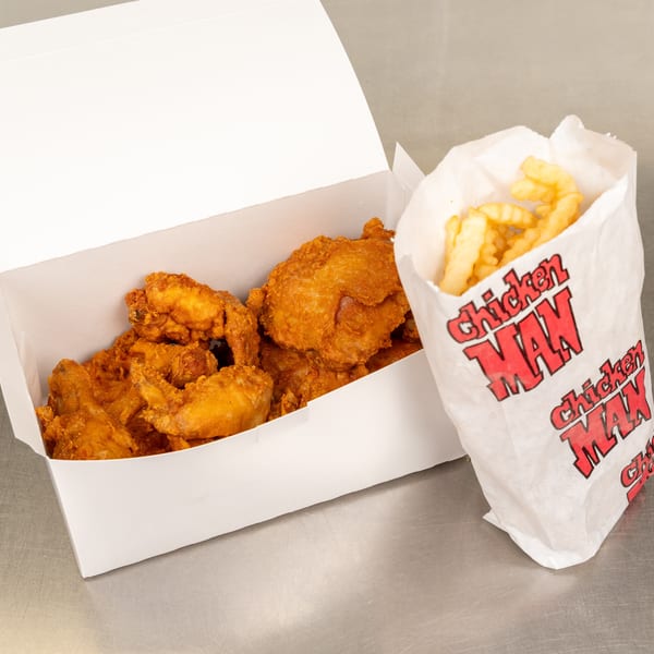 A white box of fried chicken and a paper bag of crinkle-cut fries from Chicken Man.