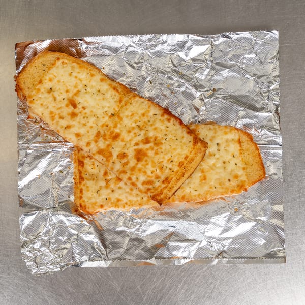 Two slices of cheesy garlic bread, golden brown and sprinkled with herbs, on crumpled aluminum foil.